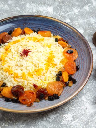 front view yummy shakh plov cooked rice dish with raisins inside plate white floor dinner cooking rice dish meal