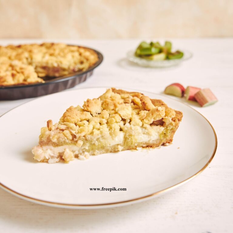 🥧Kəsmikli piroq vertical shot of a slice of crispy rhabarbar cake tart on a white plate with some fruits